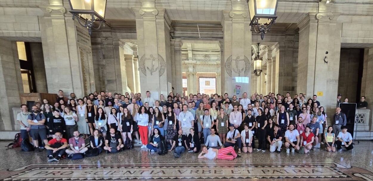 Group photo of over 120 participants at EEG101 OHBM Brainhack 2026